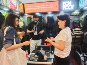 Two visitors discussing products at the exhibition booth