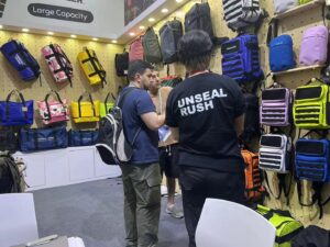 Two visitors discussing products at the exhibition booth