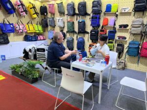 Exhibitors interacting with clients at the booth