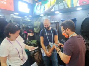 Exhibitors interacting with clients at the booth