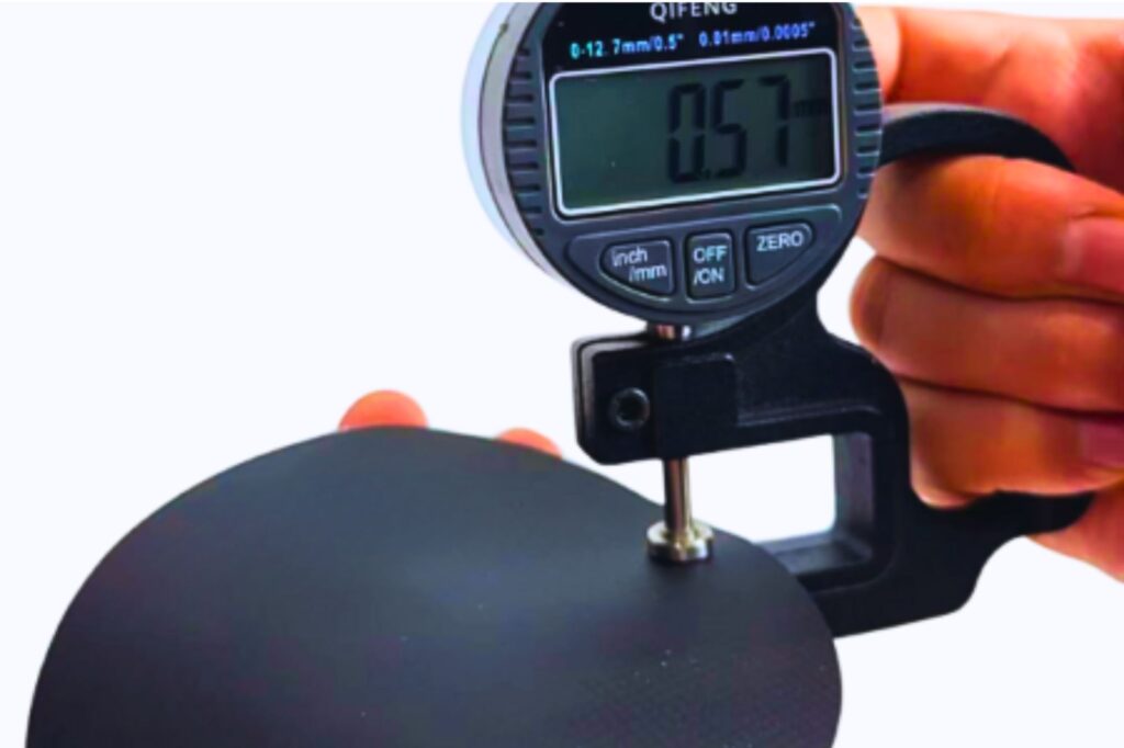Digital caliper measuring sport bag fabric thickness for reliable quality in B2B custom sport bags